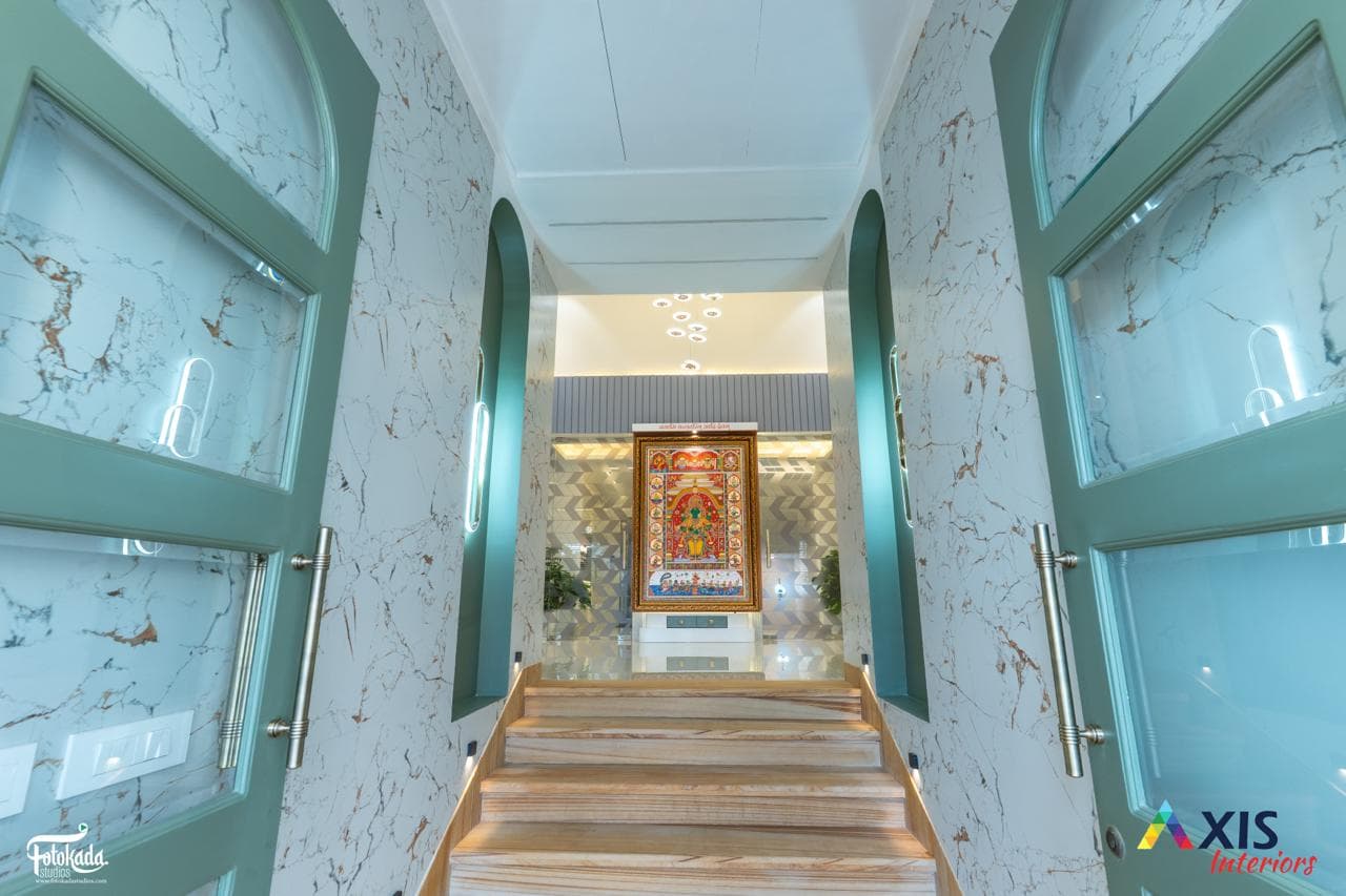 Green marble arched entrance hallway with wooden staircase