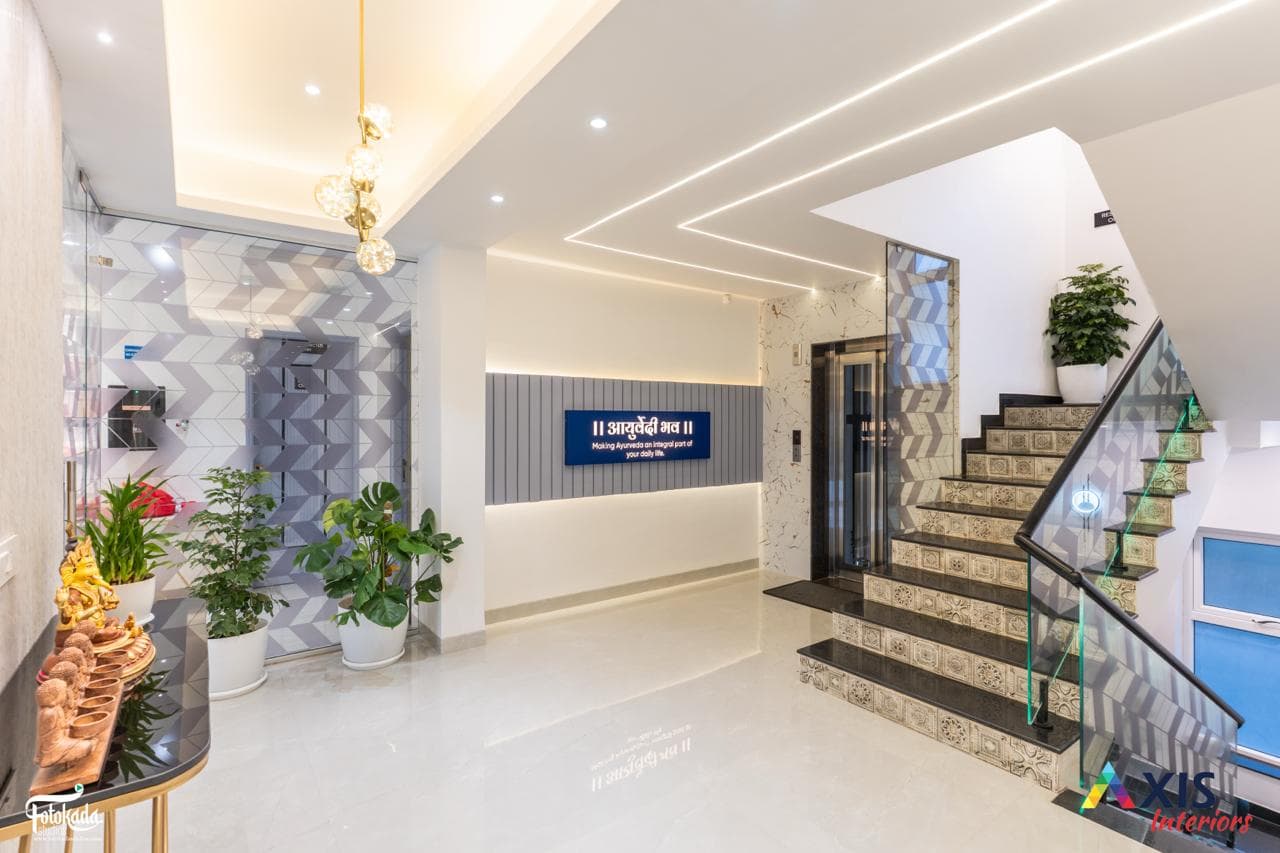 Grand lobby with patterned staircase and Ayurvedi Bhava signage